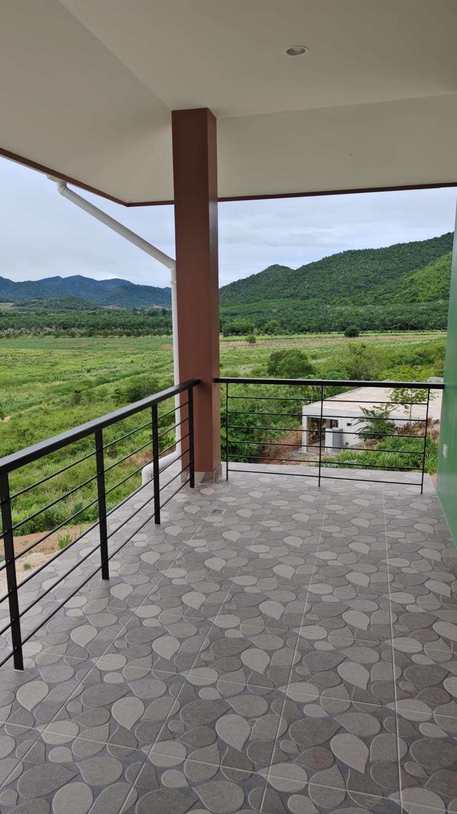 Balcony with patterned tile and farmland view