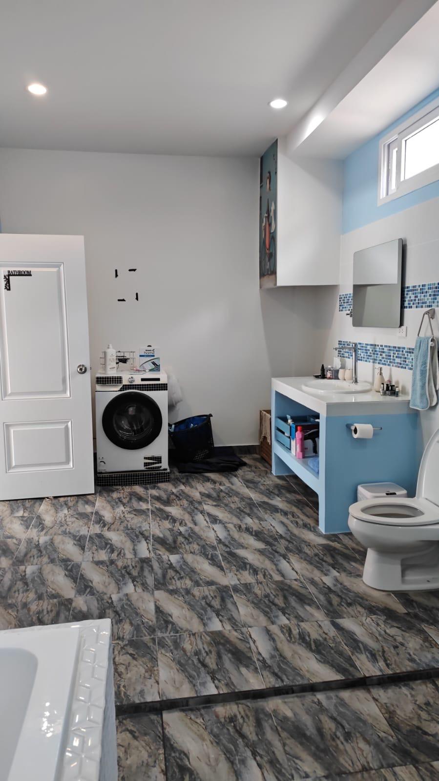 Bathroom with built-in laundry area