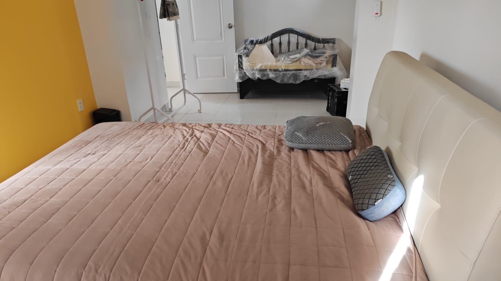 Furnished bedroom with mustard yellow accent wall