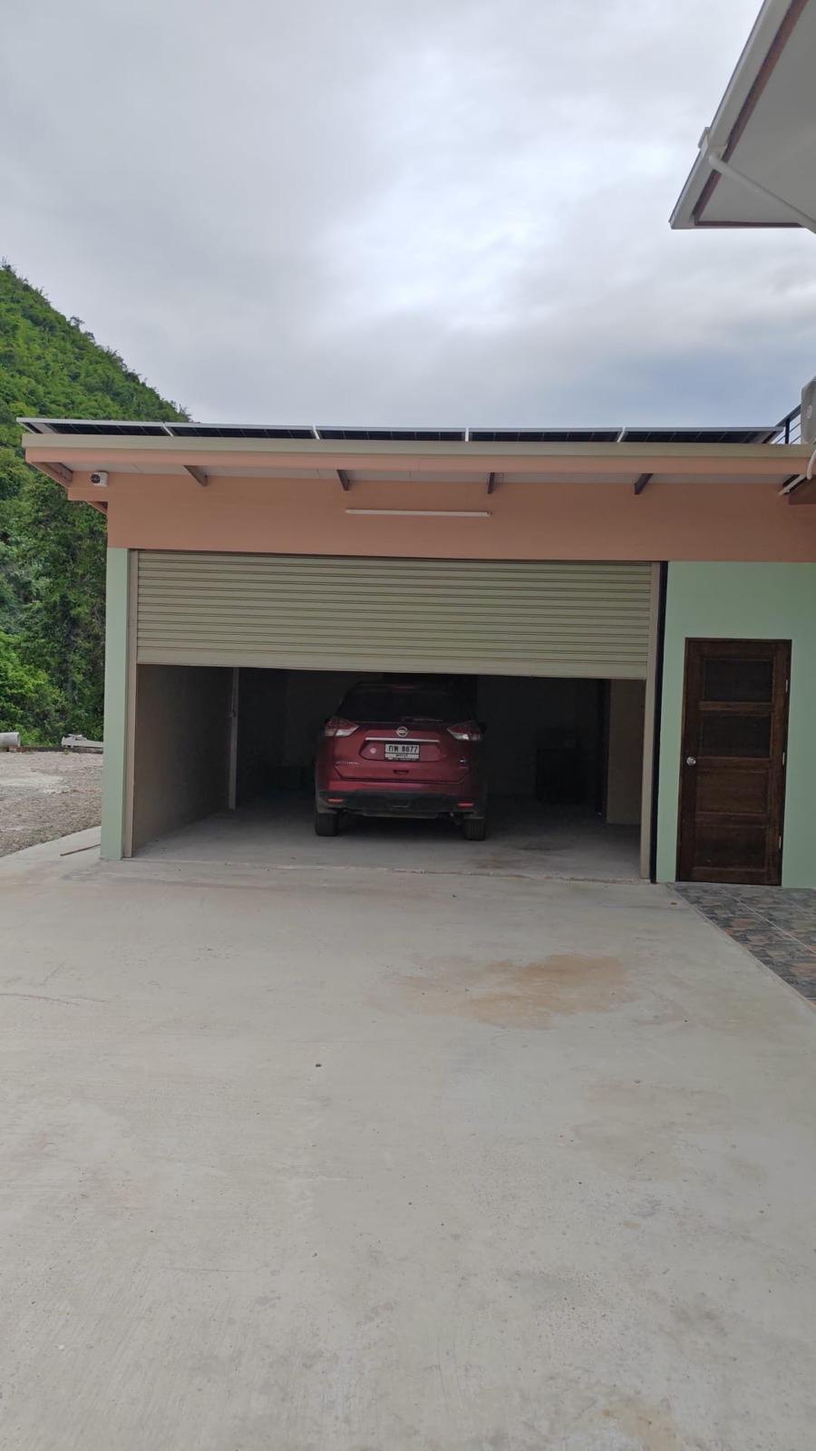 Covered garage with car and rooftop solar panels