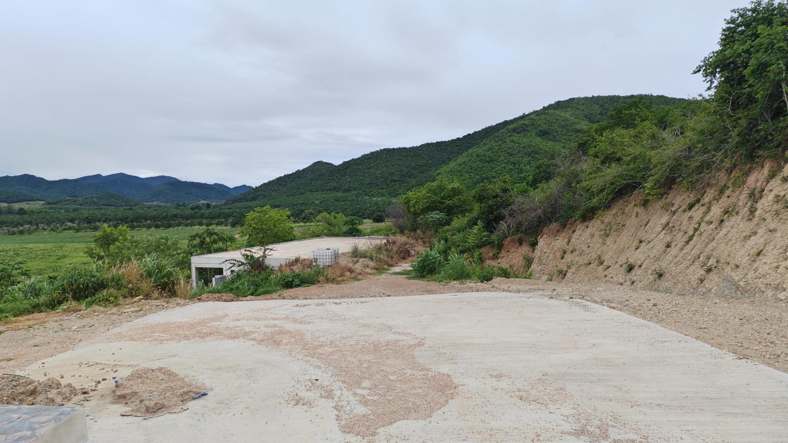 View of the land and access road, framed by hills