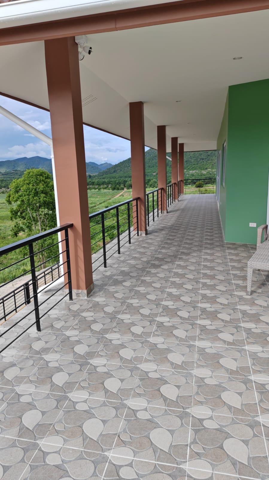 Long covered walkway with columns and valley view